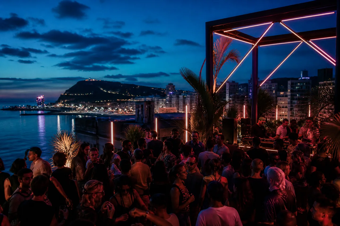 Rooftop nightlife event above a coastal city